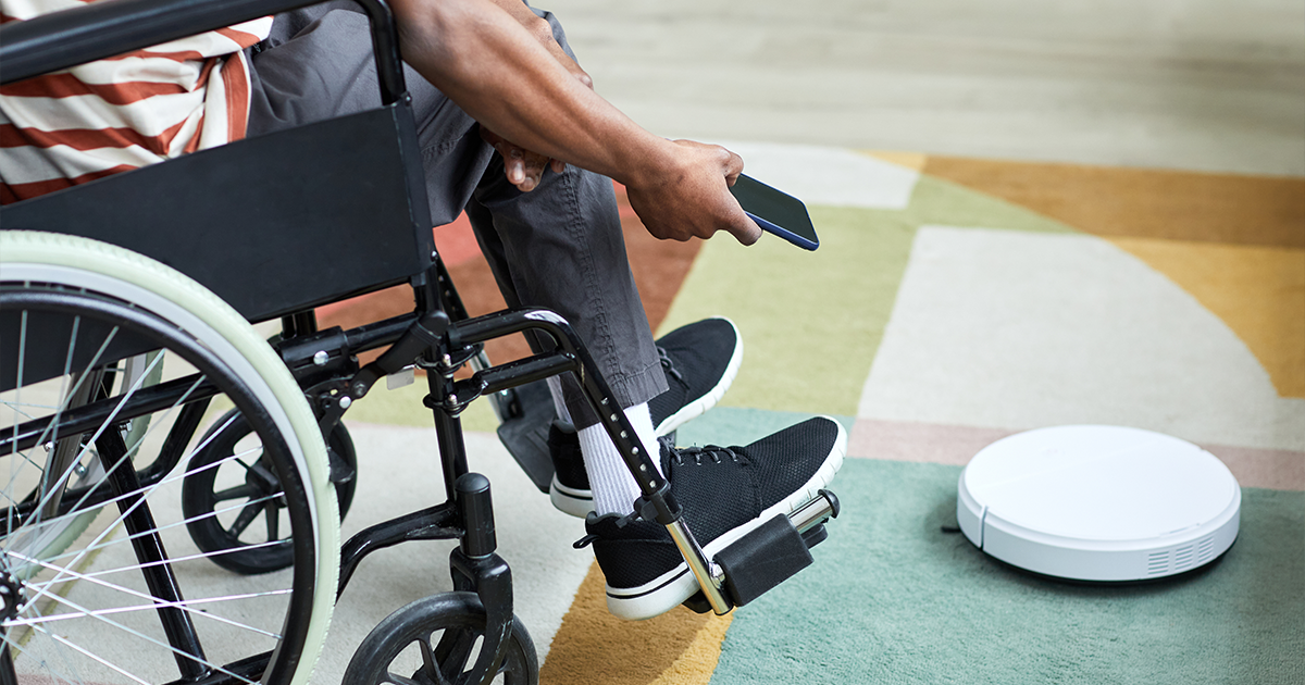 Person using robot vacuum cleaner.