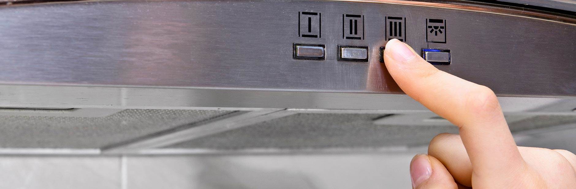 Person turning rangehood on.