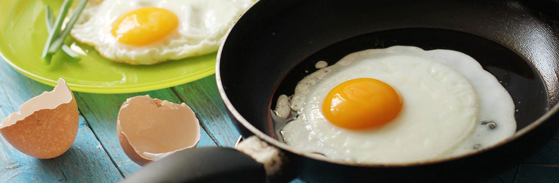 Cooking an egg in a frying pan.