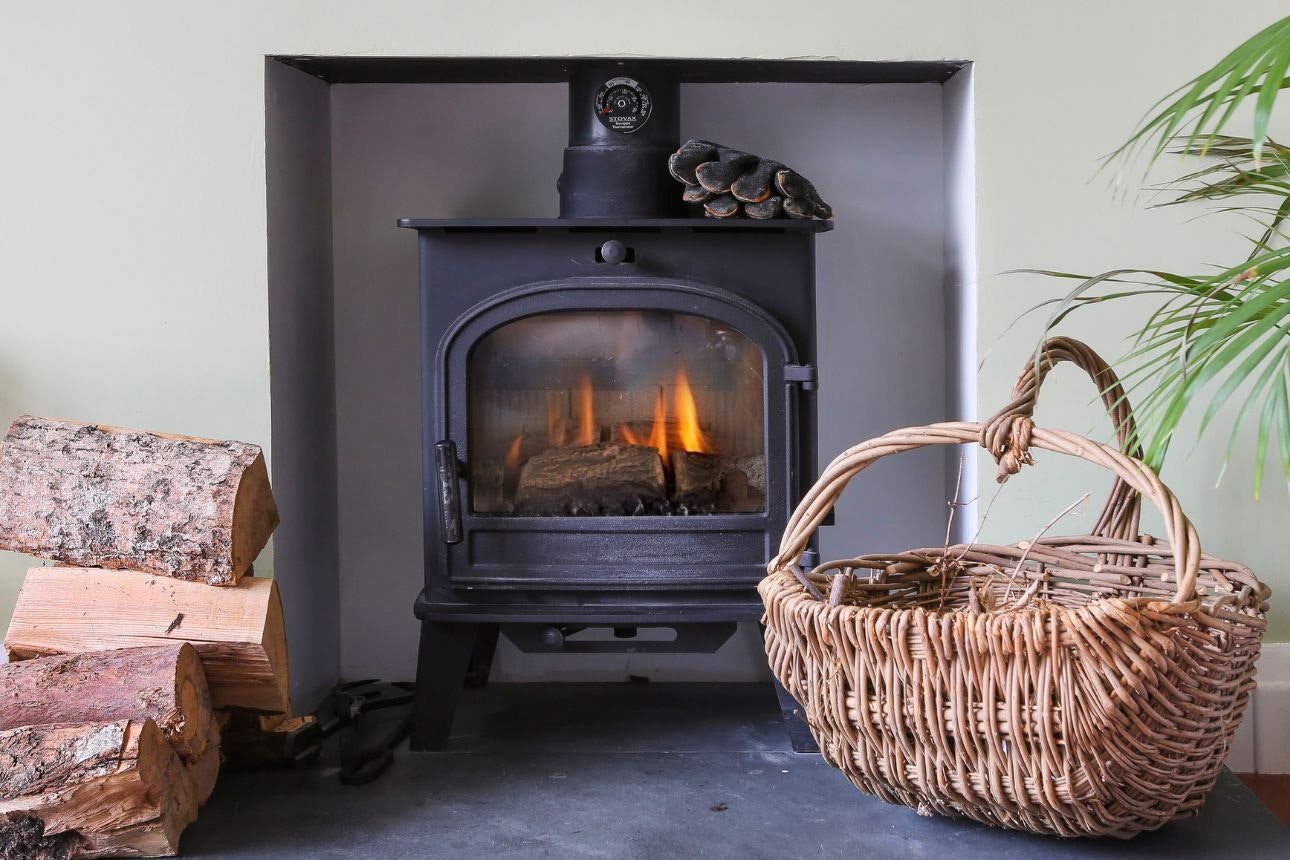 Woodburner lit inside a house.