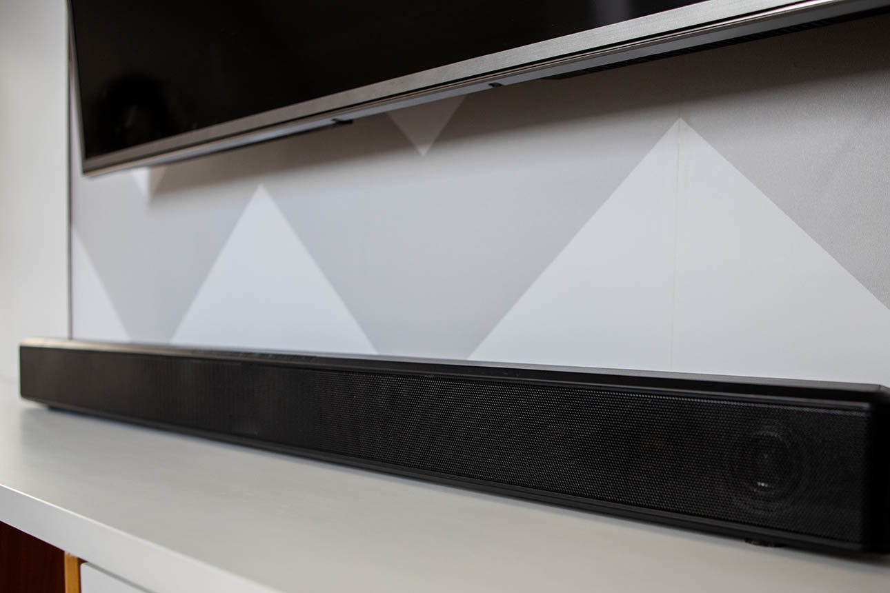 Photo of sound bar on cabinet below TV.