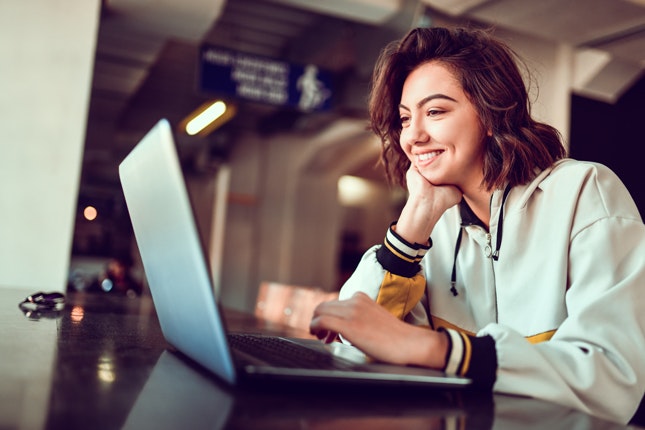 Close-up of person typing on a laptop keyboard.