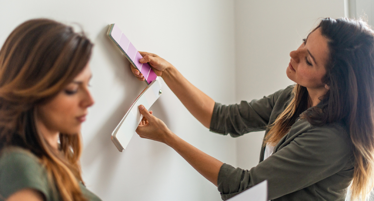 Couple choosing the right color for new apartment.