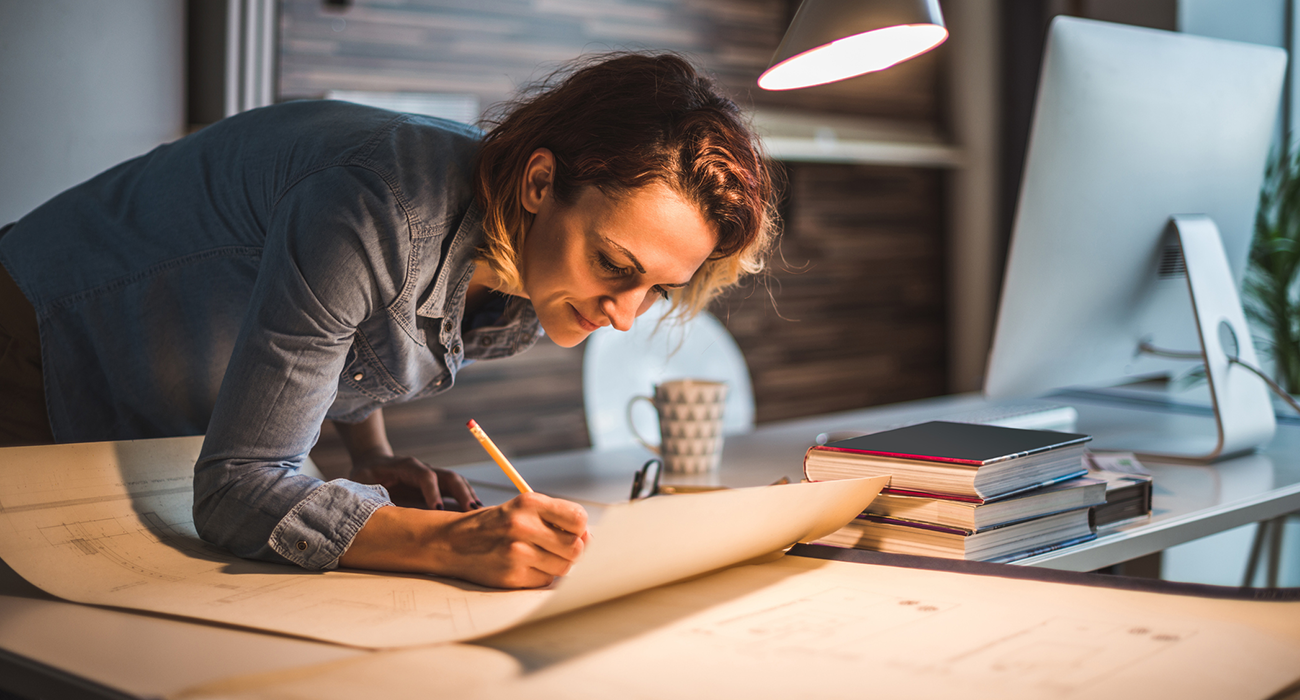 Shot of young architect working in her office.