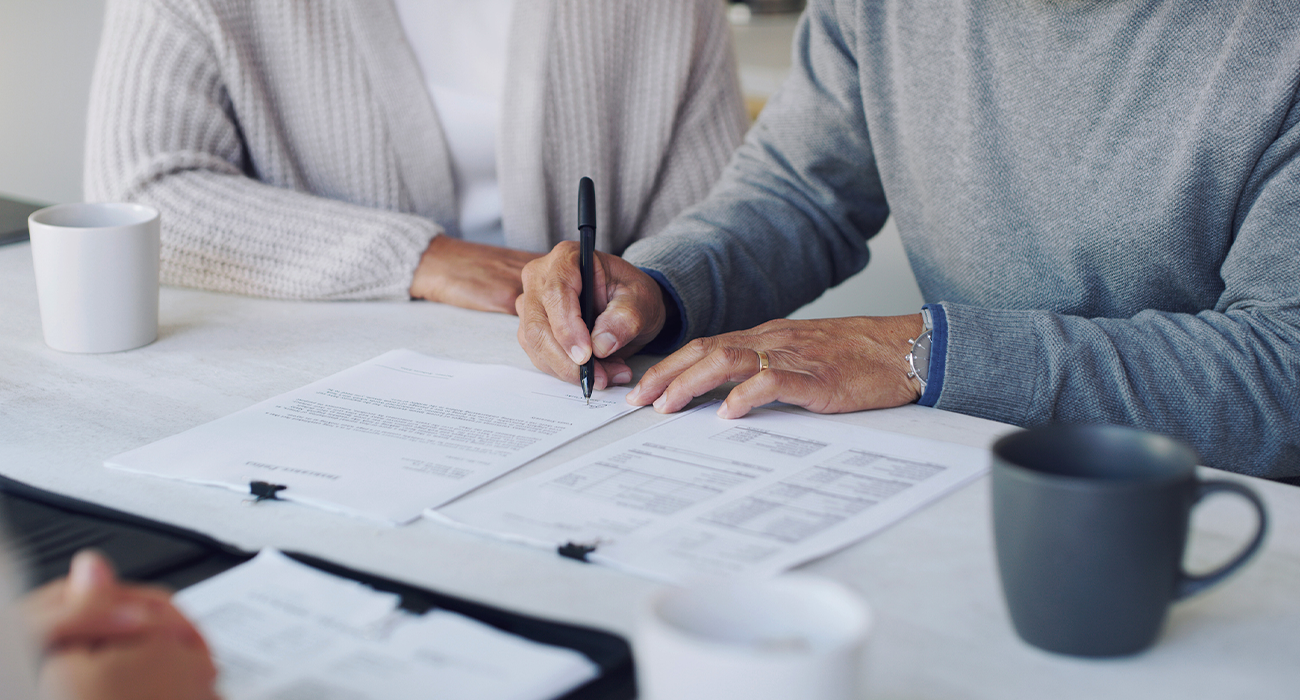 Cropped shot of a senior couple meeting with a consultant to discuss paperwork at home.