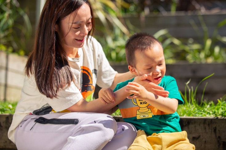 Image of a mother applying sunscreen to her child