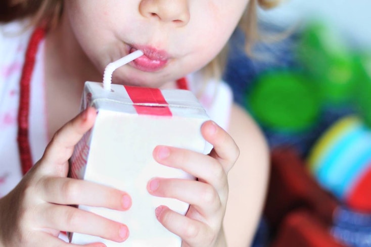 Image of a baby drinking a juice box
