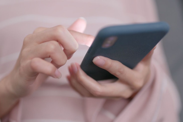 Image of woman using her phone