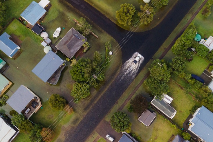 Image of a car driving through floods