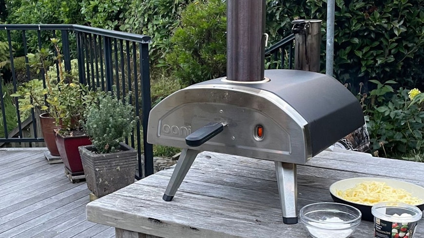 Photo of pizza oven on a bench outside