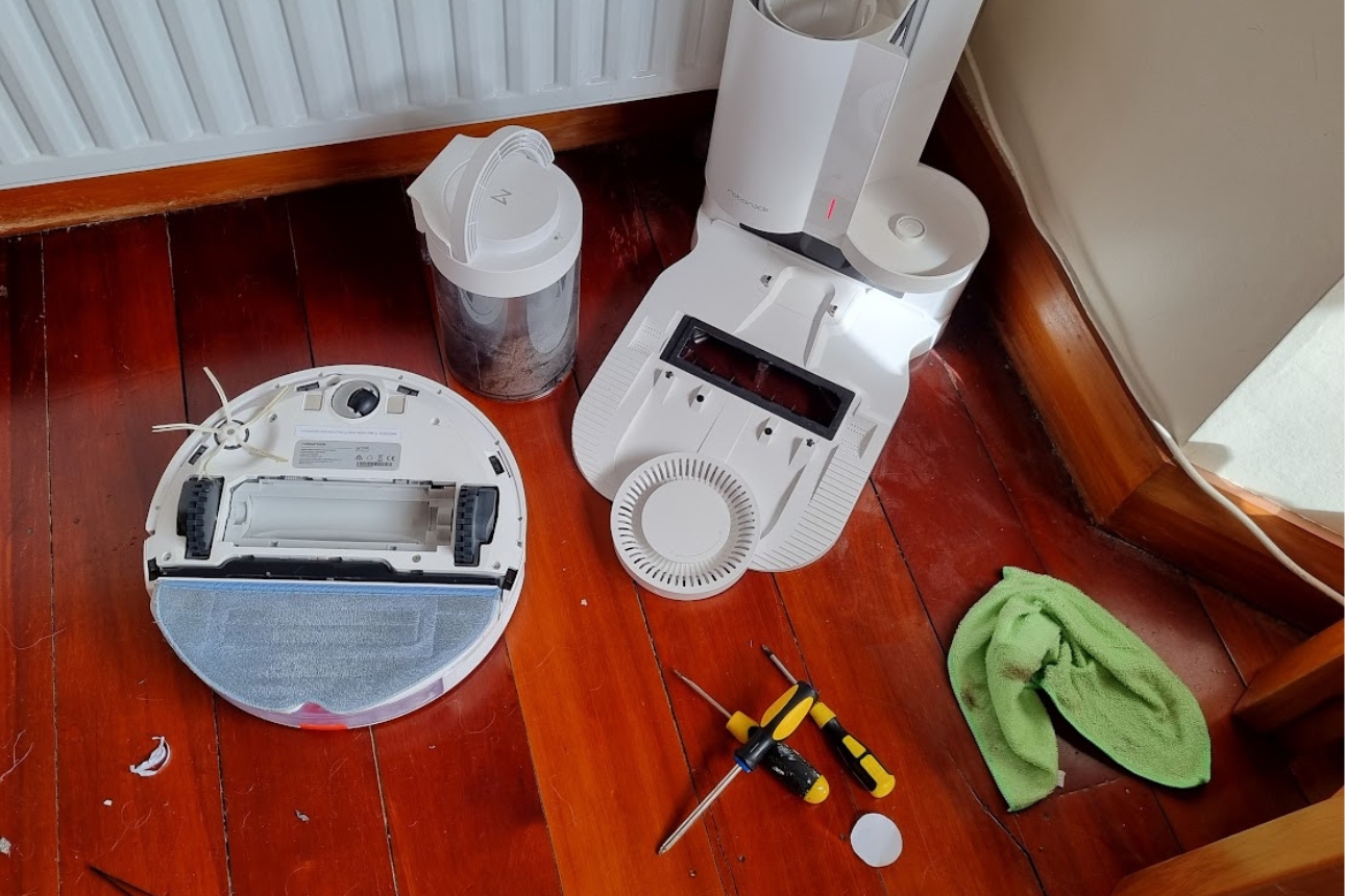 Robot vacuum maintenance — checking the dustbin