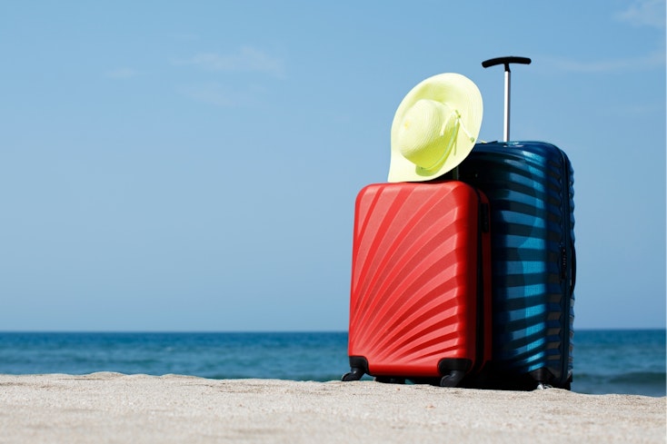 Image of suitcases on a beach