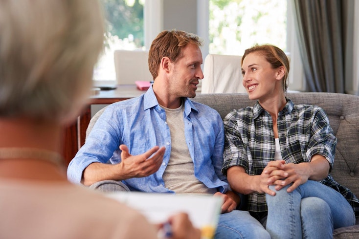 Couple talking to a mortgage adviser