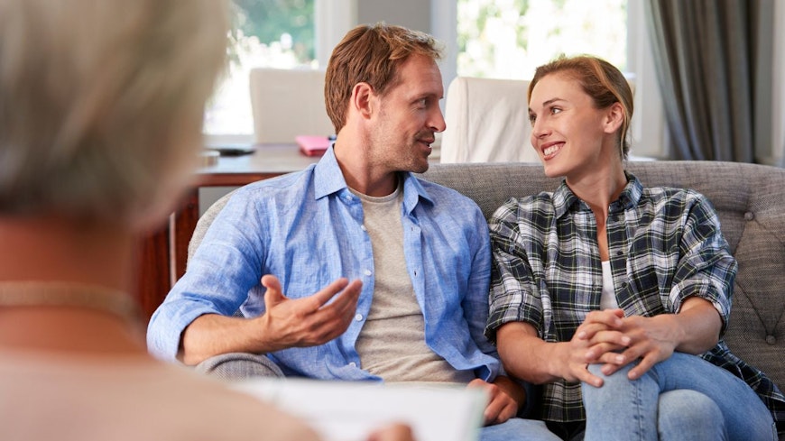 Couple talking to a mortgage adviser