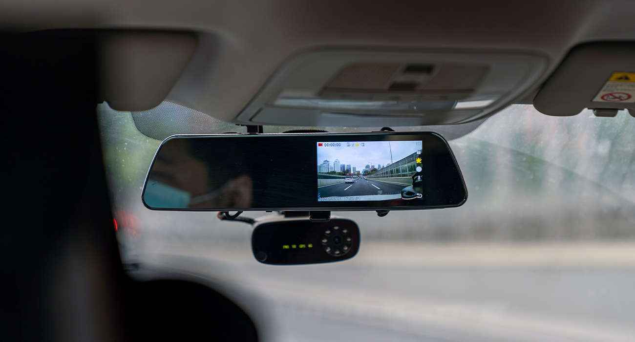 Dashcam installed on car window.