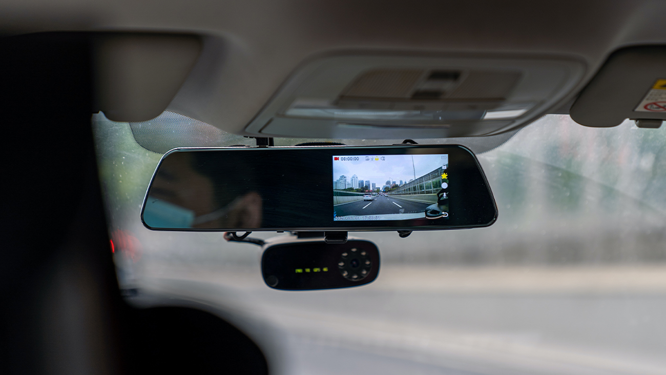 Dashcam installed on car window.