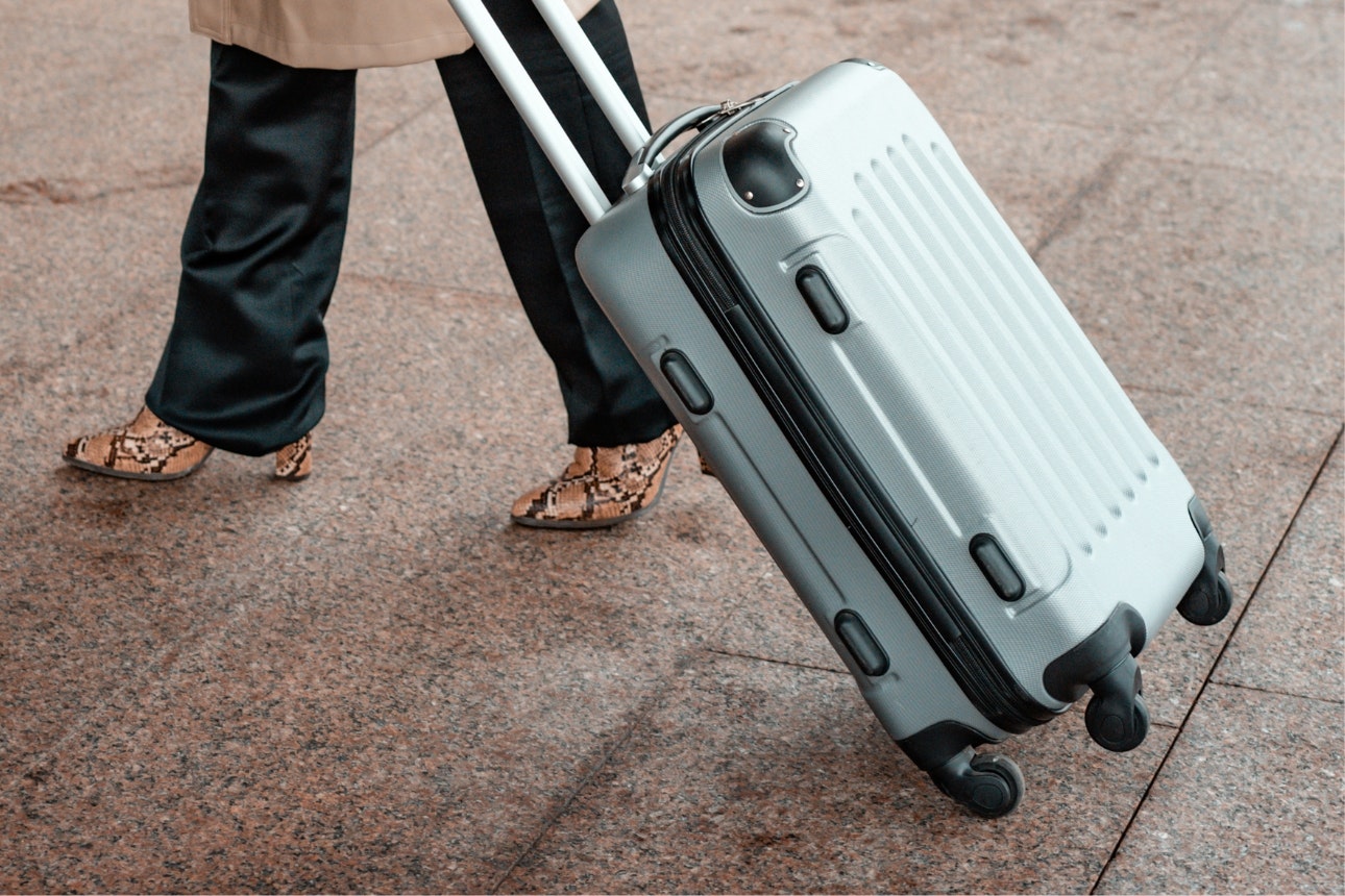 Woman with grey suitcase.