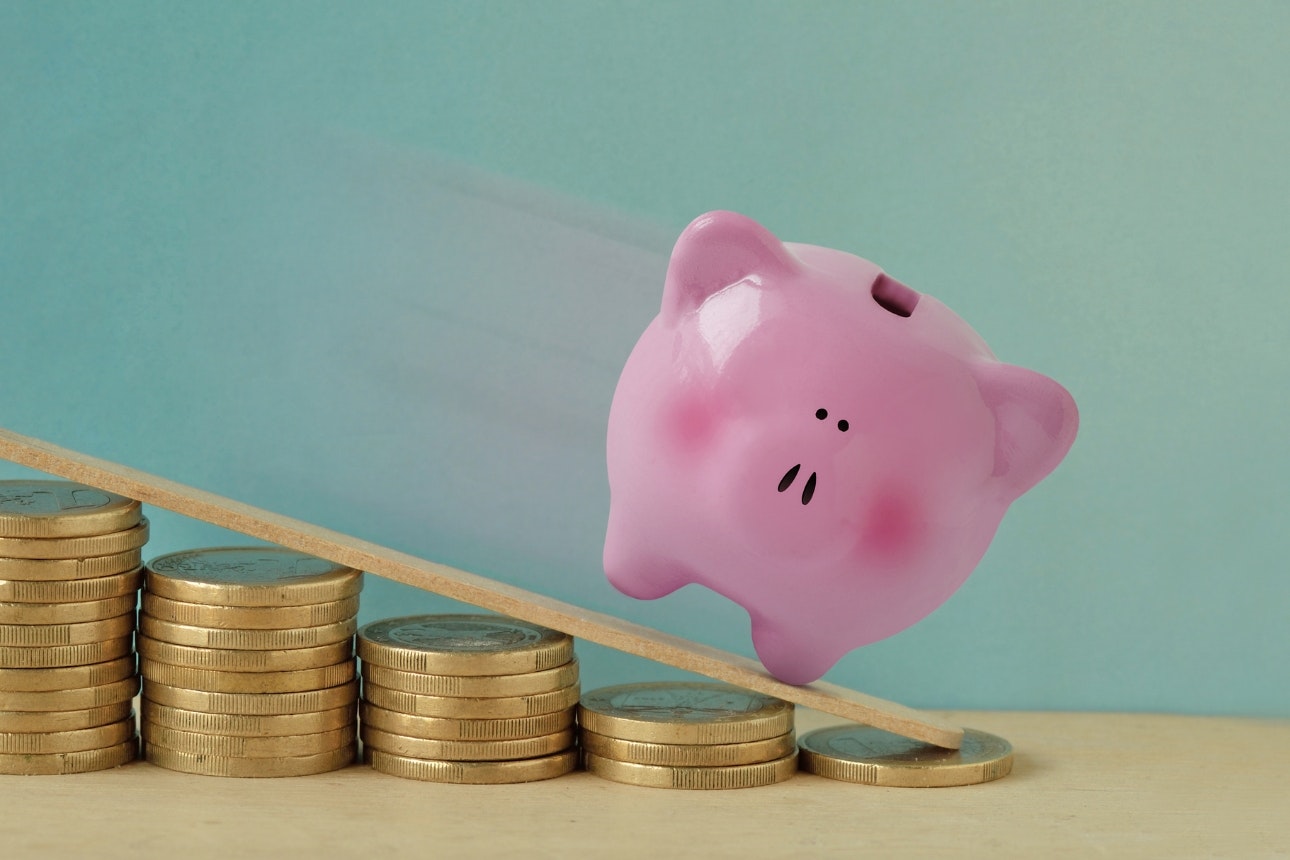 Piggy bank falling down ramp.