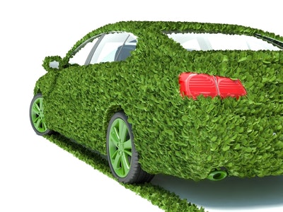 Green EV with plants, symbolising that EVs are more eco-friendly than regular cars.