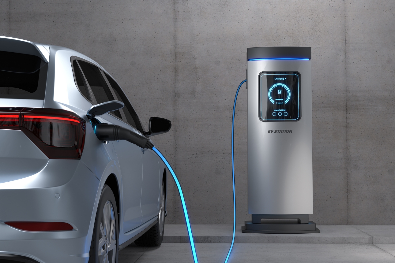 Electric vehicle charging at a charging station.