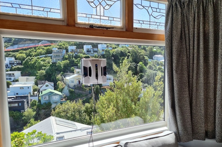 Window cleaning robot attached to window.