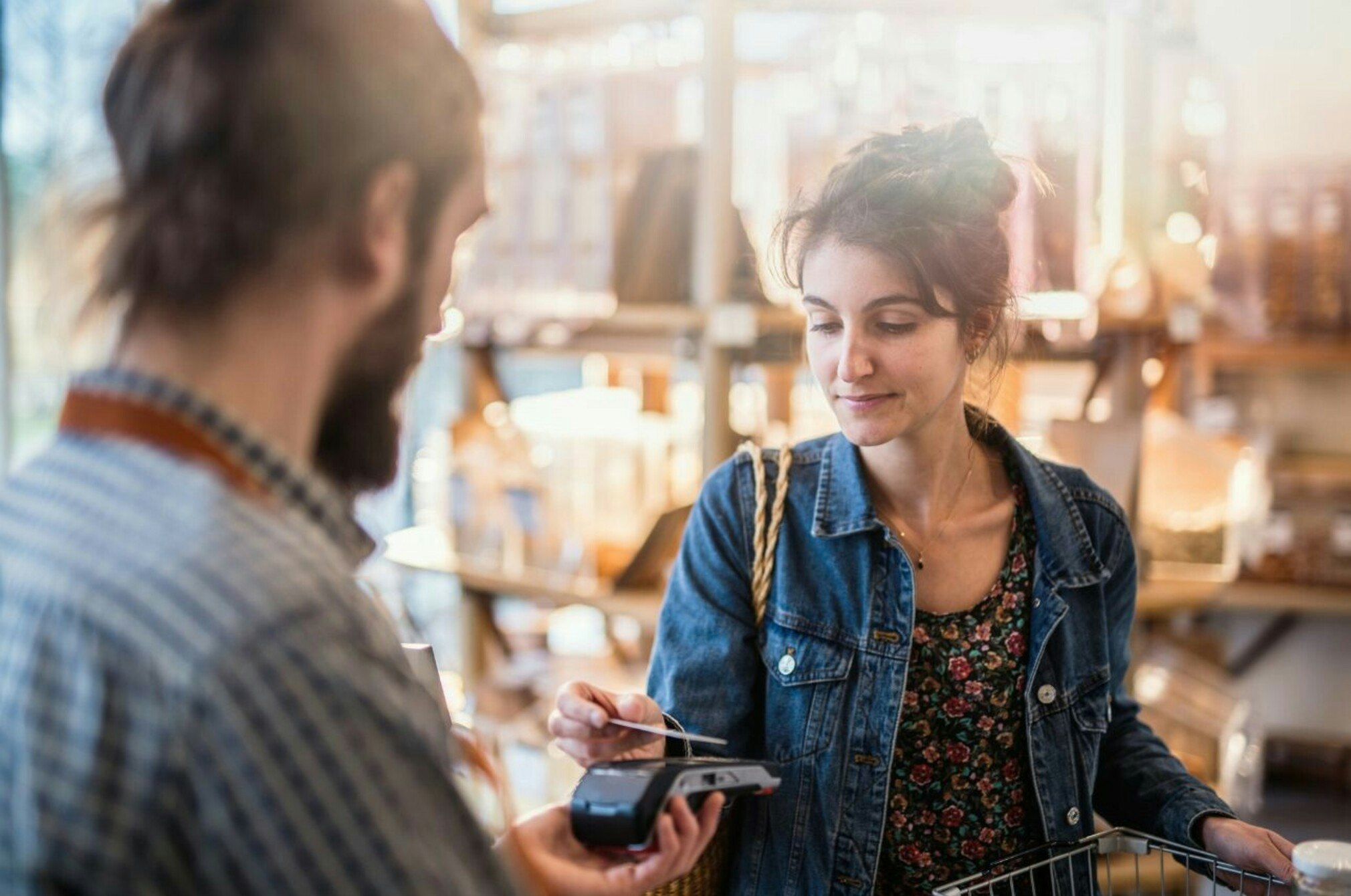 Woman paying with card, contactless payment.