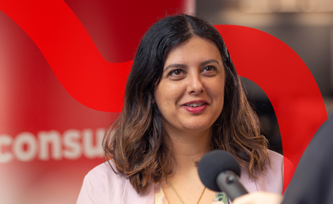 Image of a woman speaking into a microphone