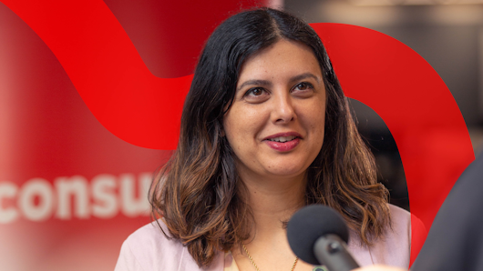 Image of a woman speaking into a microphone