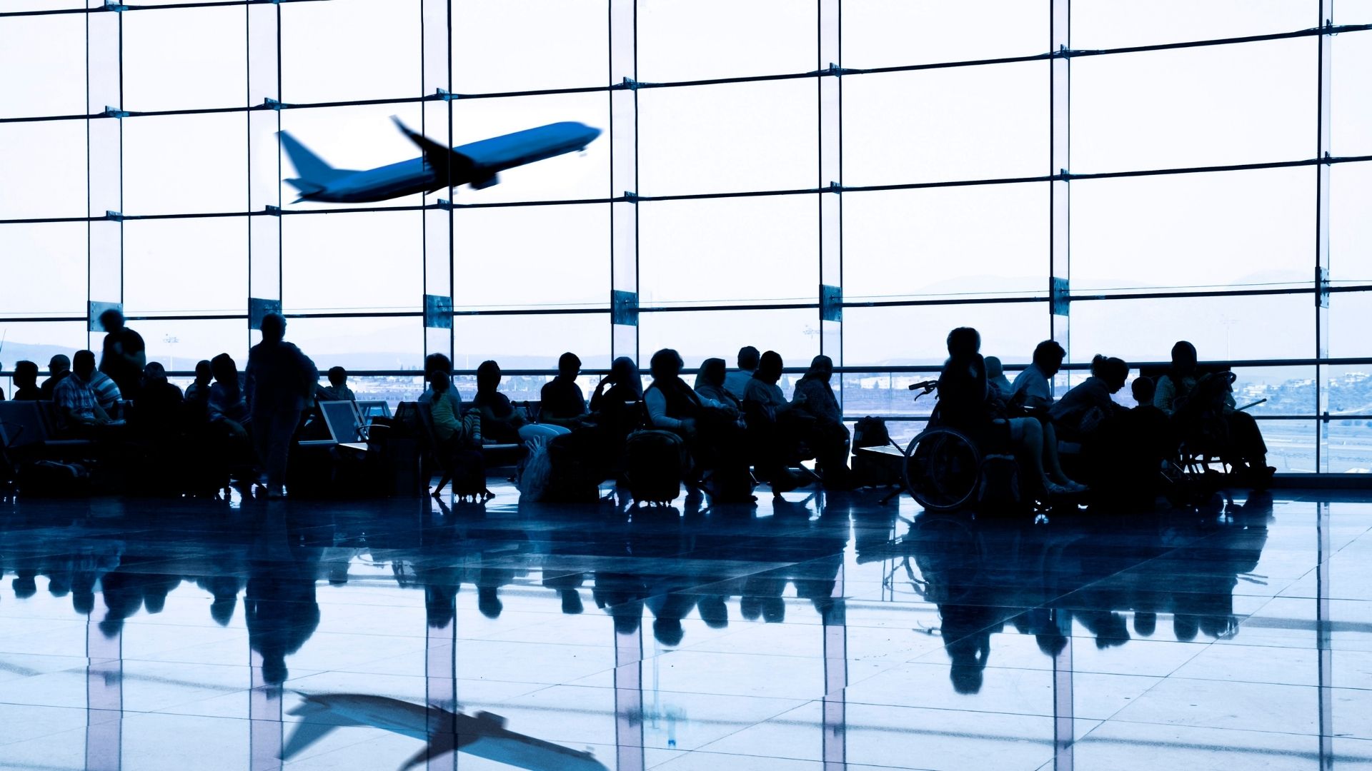 Travellers waiting at an airport.